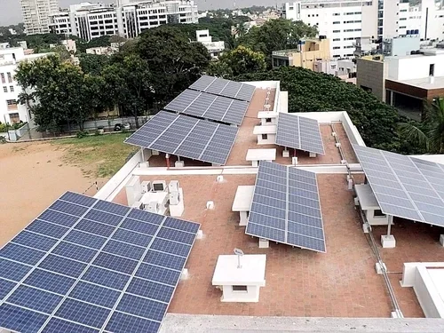 Commercial rooftop fitted with multiple solar panel arrays