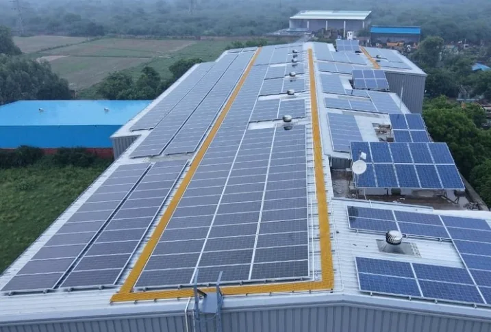 Long industrial rooftop covered with solar photovoltaic modules